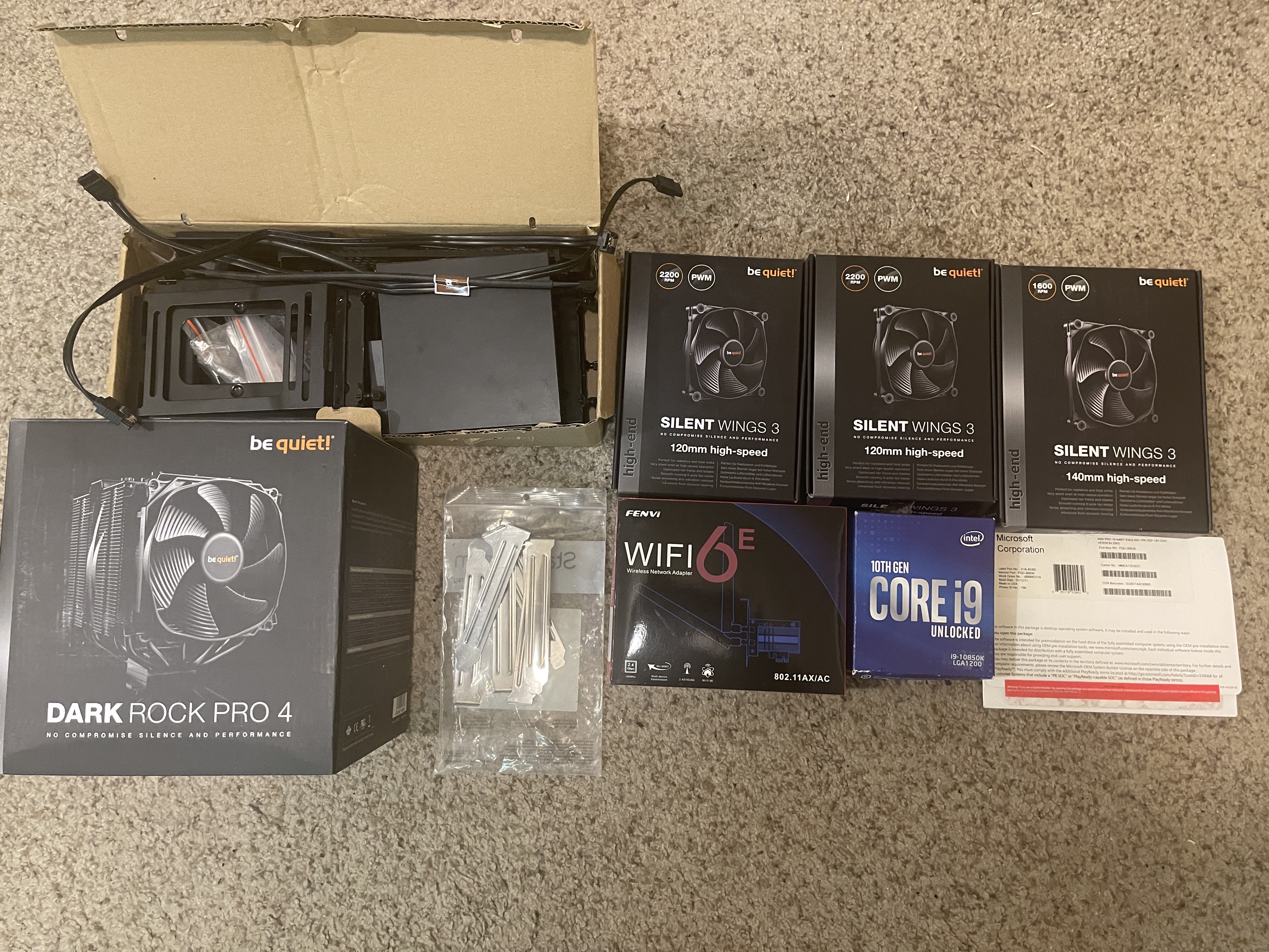 extra fans, heat sink case, box of case accessorites, Windows 10 Pro DVD, i9 intel CPU box, wi-fi/bluetooth box, extra hardware